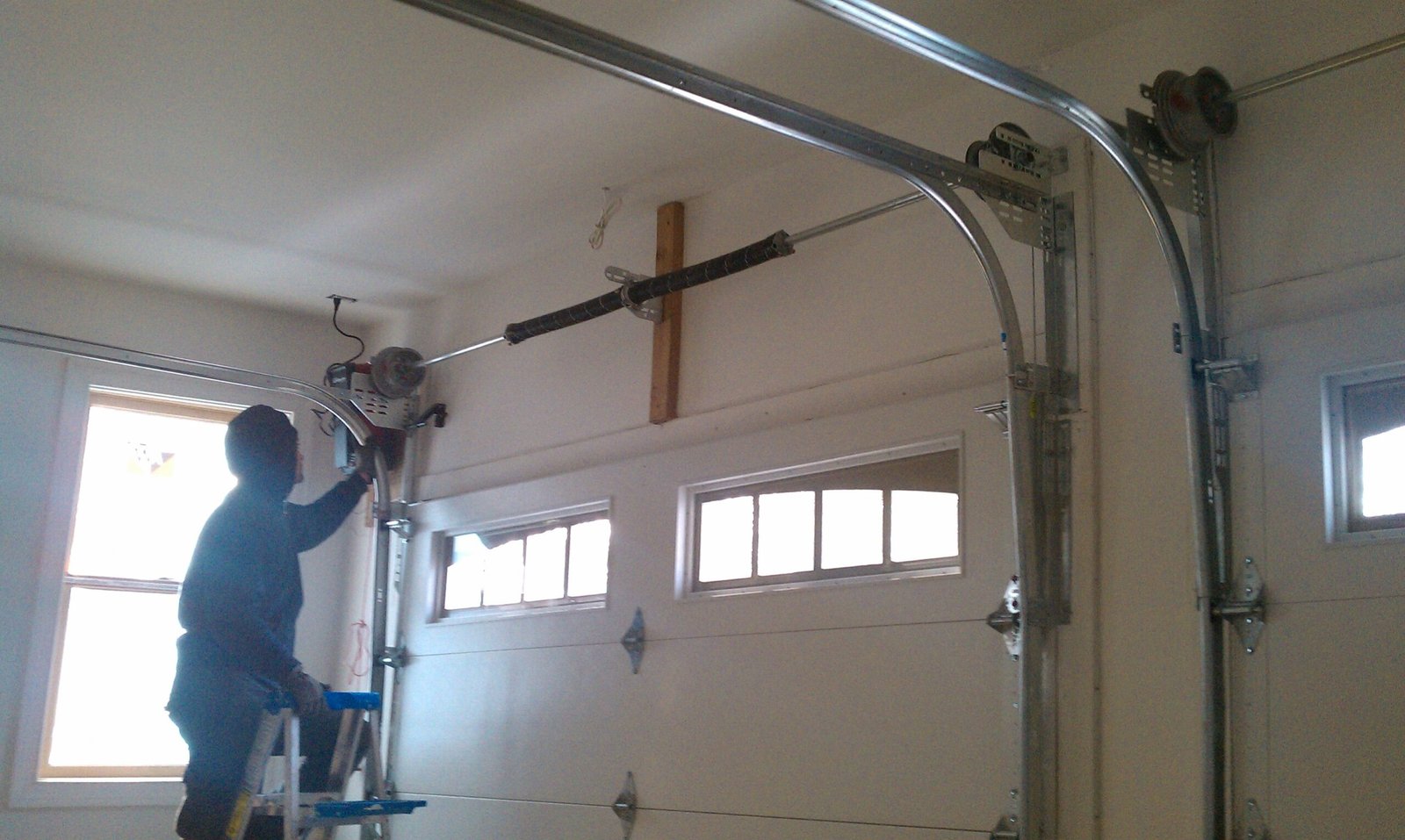 A man repairs garage door